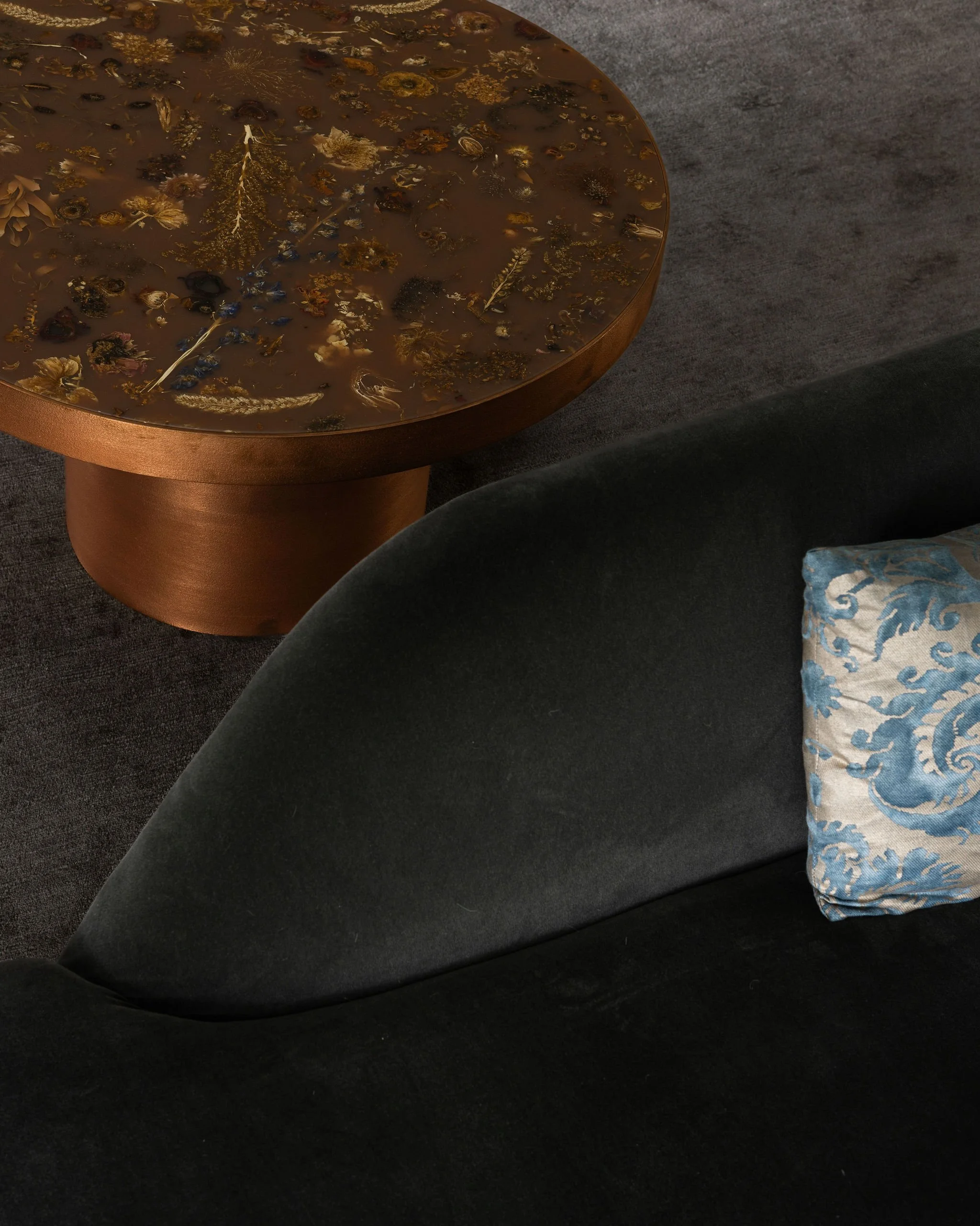 Primary bedroom detail featuring a Pinch chaise upholstered in Holland & Sherry fabric and a resin-and-flower coffee table by Marcin Rusak.