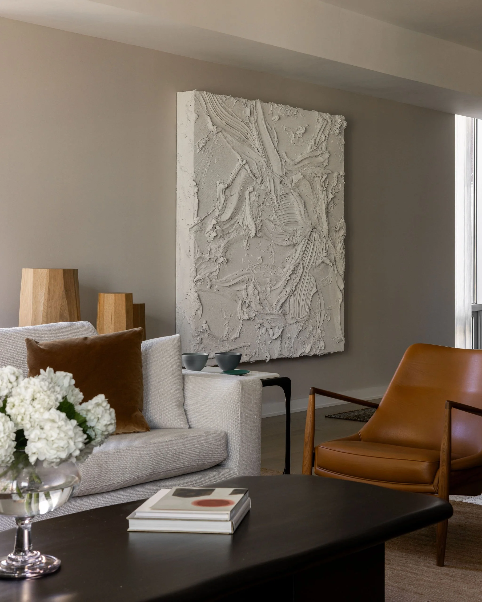 Luxury Georgetown condo living room by Austin interior designer Laura Roberts Design featuring a commissioned Jason Martin painting from Lisson Gallery, Minotti sofa, Seal chair, and custom coffee table.