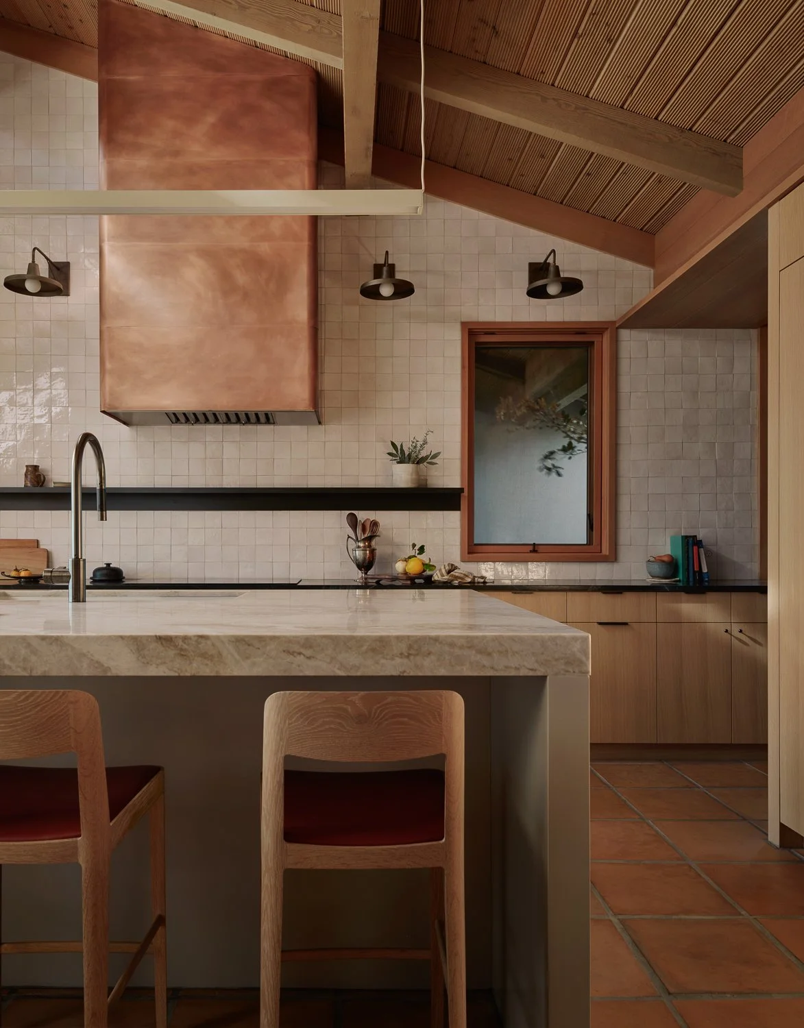 Custom kitchen design in a Sonoma wine country home featuring a copper vent hood, hand-glazed zellige tile backsplash, and a Taj Mahal quartzite island with waterfall edge.