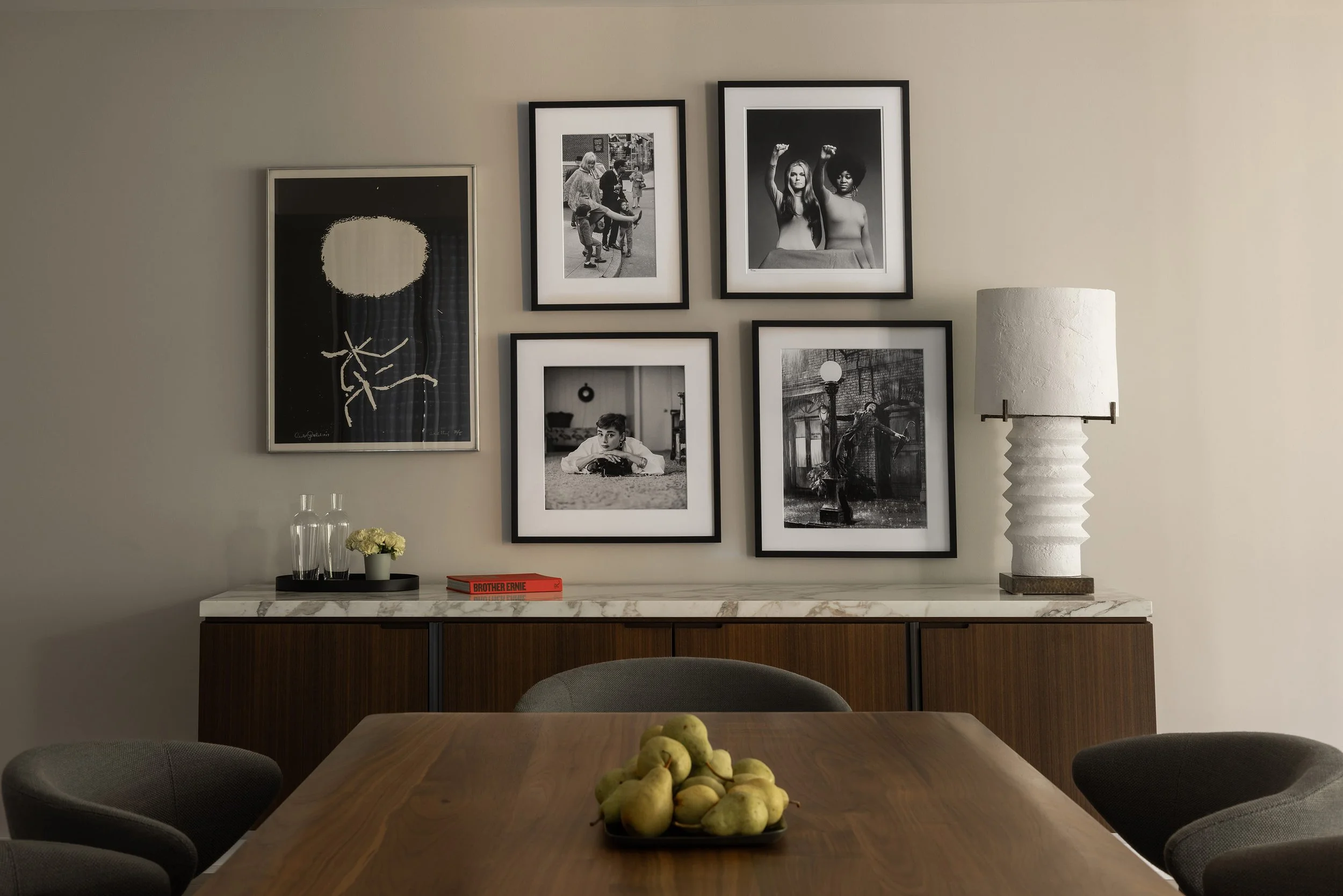 Salon Art Gallery Wall Installation  in Georgetown DC condo with Plaster lamp from Blackman Cruz. Gottlieb print anchors the installation. Walnut dining table with the Mills Minotti dining chairs by Austin Interior Design firm, Laura Roberts Design.
