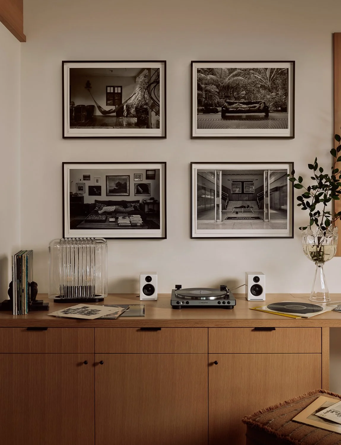 Office side of the den featuring custom white oak millwork, a built-in record cabinet, and a quartet of Gonzalo Lebrijo photographs depicting the artist sleeping in four locations across Mexico.