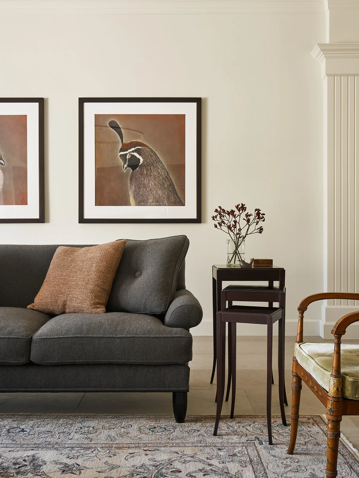 Living room in an Austin interior design project featuring a vintage reupholstered Baker sofa, antique side table, classic accent chair, and large quail photographs by Kate Breakey in a palette inspired by nature.