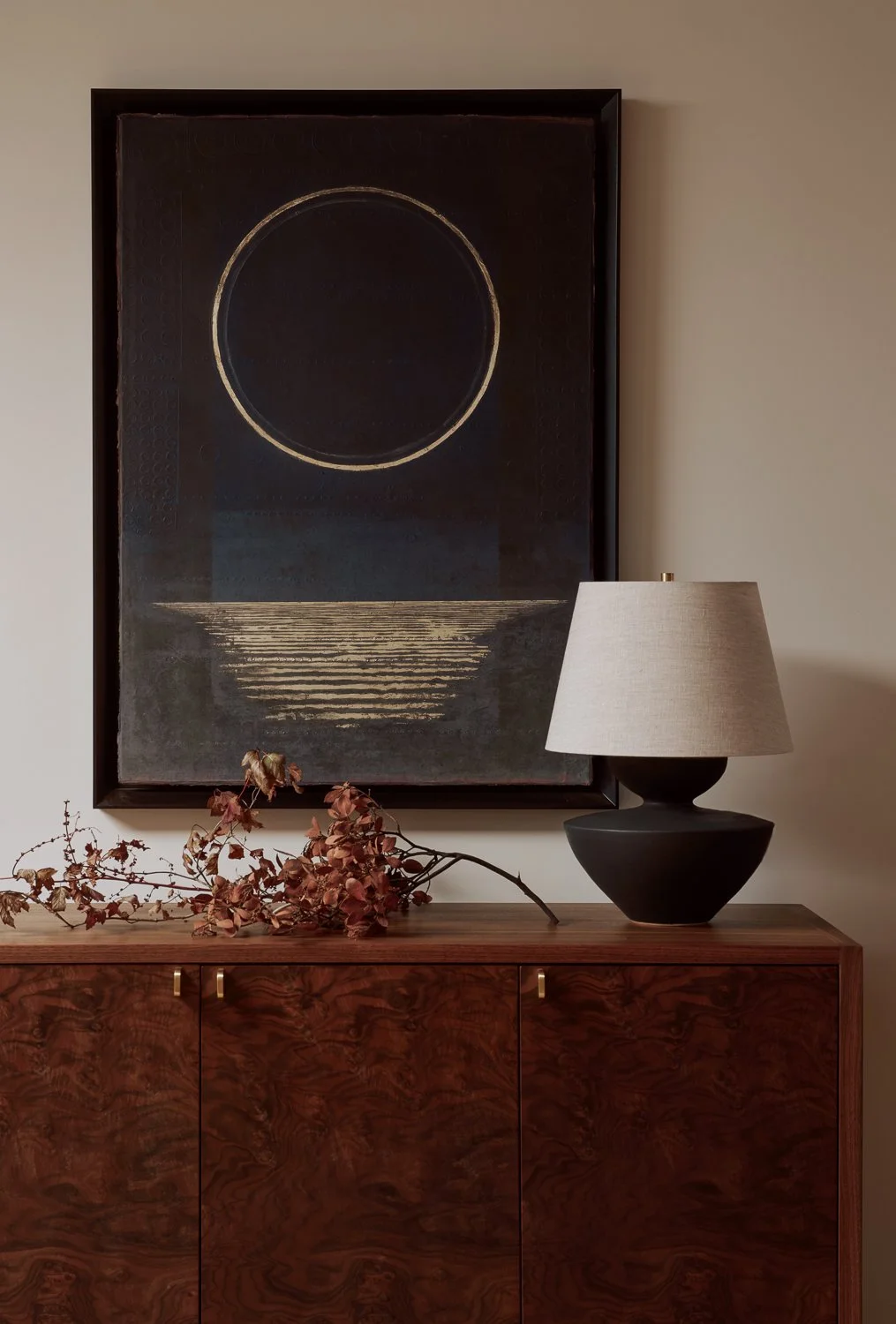 Detail of a Sonoma home foyer featuring a custom walnut credenza, a sculptural mangrove branch from the property, and Blue Moonscape by Ken Matsubara from Ippodo Gallery.