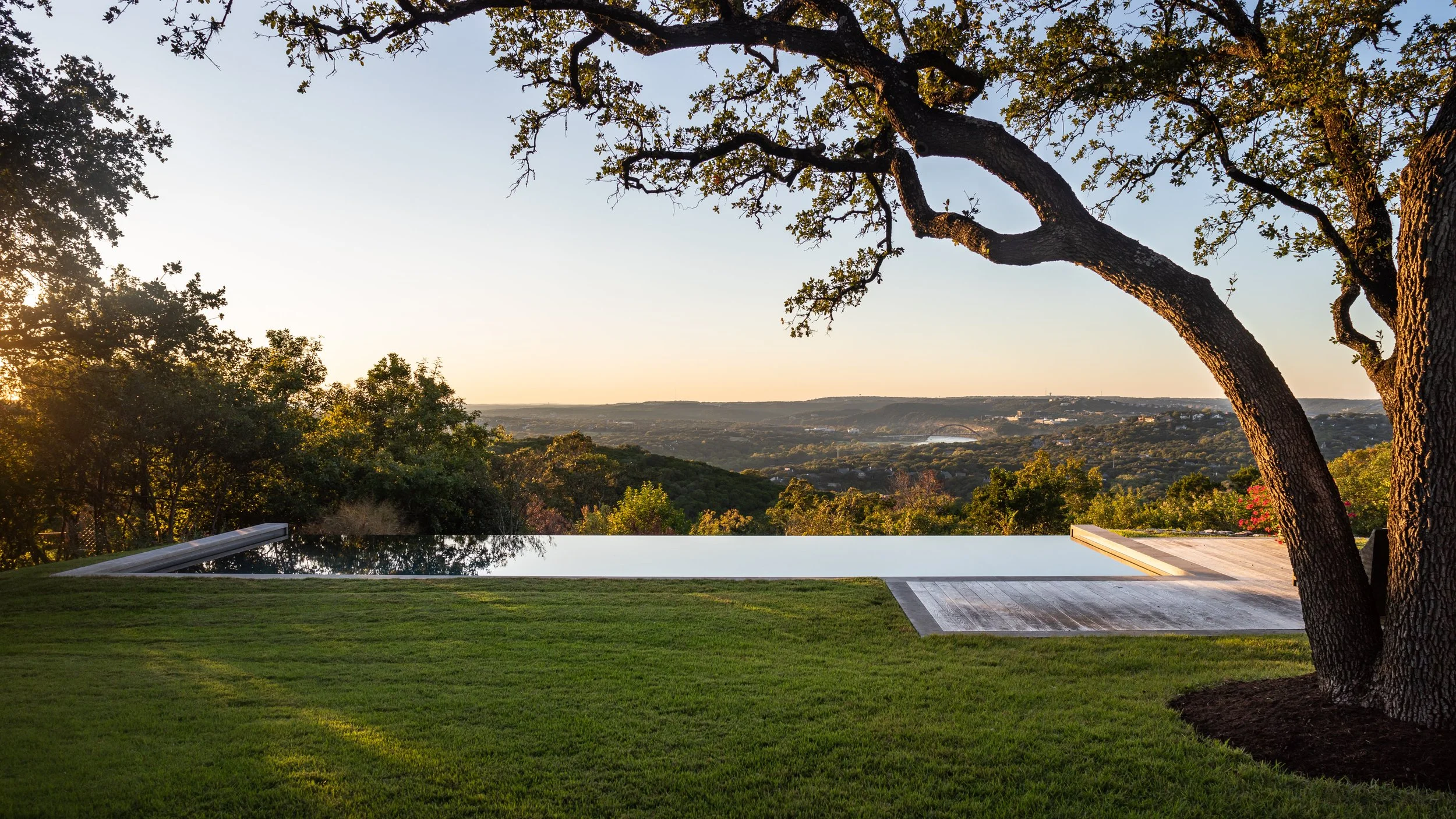 Negative-edge swimming pool with limestone decking and panoramic views of the Austin hills.