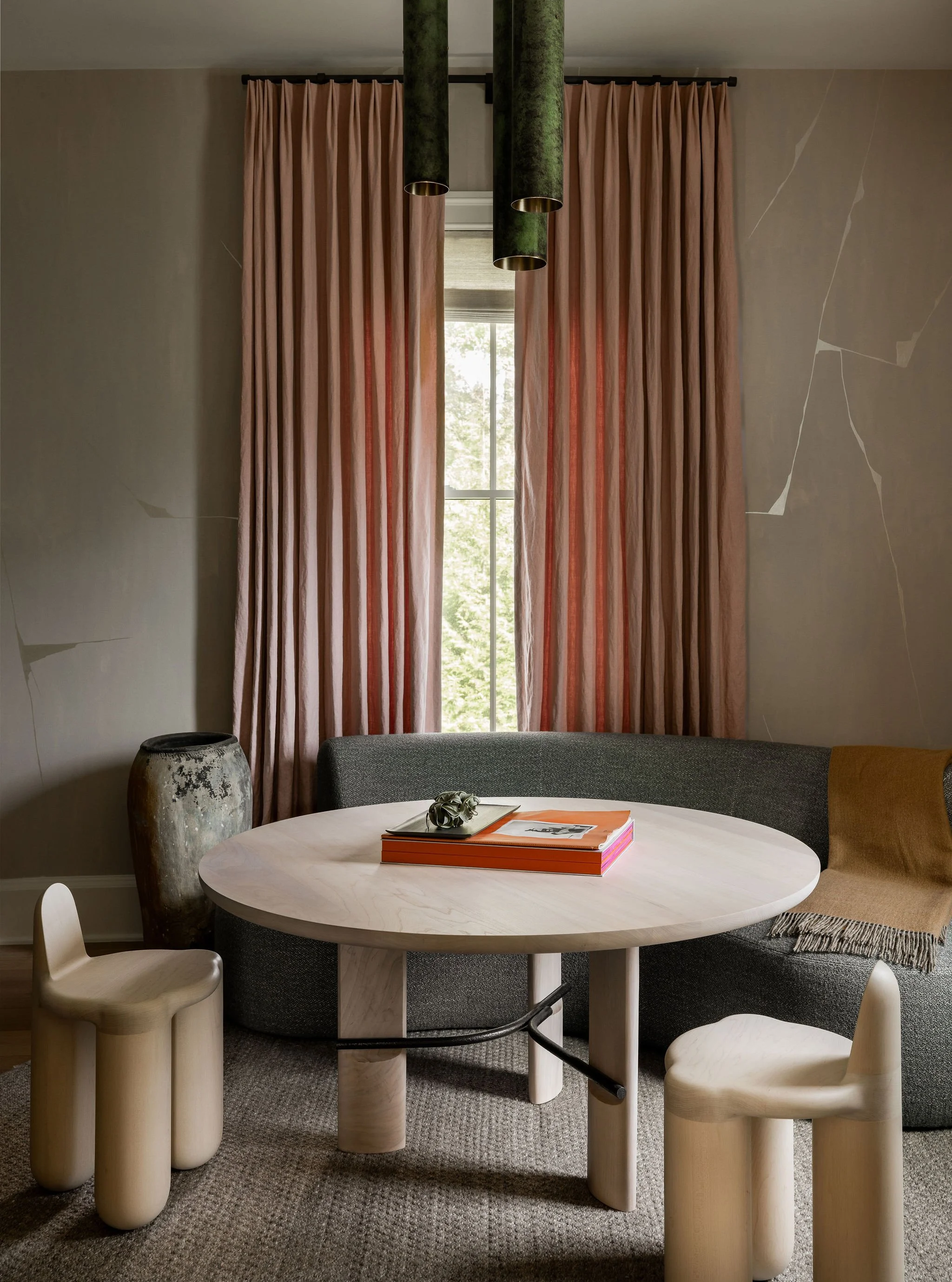 Wine room lounge in a McLean, VA home featuring Portoro Kintsugi wallpaper by Porter Teleo, a custom banquette and table by Collection Particulière, sculptural Bone chairs by Radnor, and the Multiocle Green chandelier by Mauro Mori.