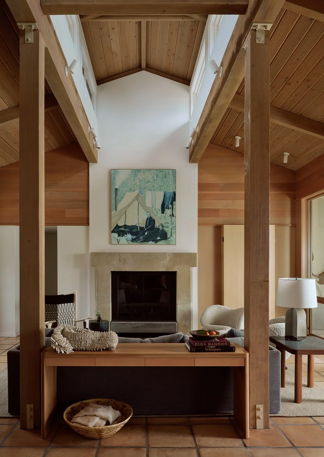 Living room in a Sonoma, California home featuring custom fir and white oak millwork, an Egg Collective sofa table, and The Prospectors by Barry McGlashan from Maya Frodeman Gallery.